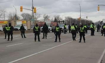 Police blocking in the intersection of Huron Church Road and Tecumseh Road West after all demonstrators and vehicles were removed from the roadway, February 13, 2022. (Photo by Maureen Revait) 