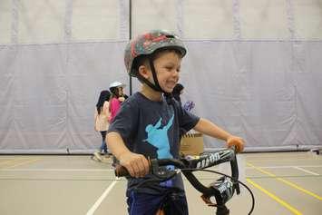 Konnor Harding, a grade-one student at Begley Public School in Windsor, beams with pride over his new bike, June 21, 2019. Photo by Mark Brown/Blackburn News.