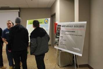 Visitors to an open house on off-road biking view visual aids at the WFCU Centre in Windsor, January 25, 2018. Photo by Mark Brown/Blackburn News.