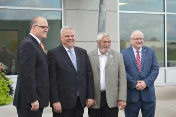 Windsor Mayor Drew Dilkens, left, Steffen May, CFO of Kauth; Essex County Warden Tom Bain and WEEDC CEO Stephen MacKenzie outside the Kauth North America building near Windsor Airport, October 4, 2018. Photo by Mark Brown/Blackburn News.