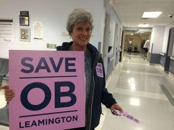 Linda Cornies greets people with a sign at the entrance of Leamington District Memorial Hospital on October 29, 2014. (Photo by Ricardo Veneza)