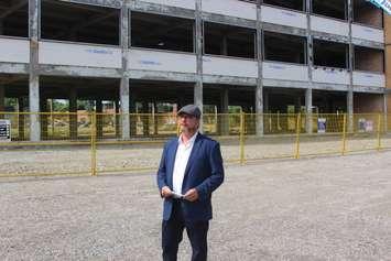 Chris Holt stands outside the Walker Power Building project in Walkerville on July 16, 2018, announcing his bid for a second term on City Council. Photo by Mark Brown/Blackburn News.