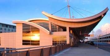 The Edward H. McNamara Terminal departures level with its distinctive curved roof and adjoining Westin Hotel, Detroit Metropolitan Wayne County Airport. CREDIT: Wayne County Airport Authority/Vito Palmisano.