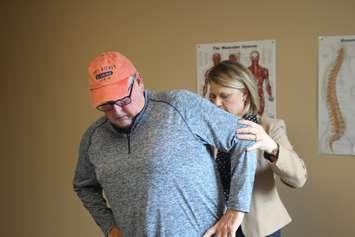 Patrick McMahon, a patient with lower back pain, is assisted by advanced physiotherapist Jennifer Nugent at one of Windsor Regional Hospital's new Rapid Assessment Centres, Ouellette Campus, Windsor, May 9, 2019. Photo by Mark Brown/Blackburn News.