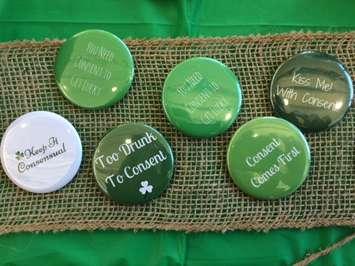 Hand-made buttons made by University of Windsor students to promote consensual sexual activity this St. Patrick's Day, March 16, 2017. (Photo by Mike Vlasveld)