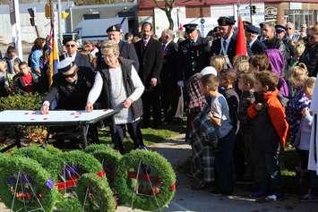 The final act of the Remembrance Day service in Thamesville participants asked to place their poppies in front of Cenotaph. Nov. 11, 2015. (Photo by Simon Crouch)