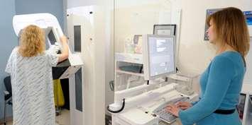 A techiniciain in Colorado Springs using a mammography machine. (U.S. Air Force photo by Dave Ahlachwede)