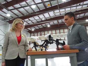London West MP Kate Young learns about a drone from Fanshawe College student Nikola Zivkovic at the Norton Wolf School of Aviation Technology , December 21, 2016. (Photo by Miranda Chant, Blackburn News.) 