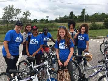 Windsor Police Cst. Lindsay Flemming, on left, helps present new bicycles to campers at the completion of the 2017 Camp Brombal at the Safety Village, July 13, 2017. Photo courtesy of Twitter/Windsor Police.