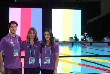 FINA Communications Director Pam Mady (centre) is flanked by FINA staff by the newly constructed temporary pool at the WFCU Centre on December 2, 2016. (Photo by Ricardo Veneza)