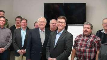 Ontario Minister of Agriculture Ernie Hardeman (front left) and Bruce Grey Owen Sound MPP Bill Walker with Farmers in Chesley. Photo by Kirk Scott.