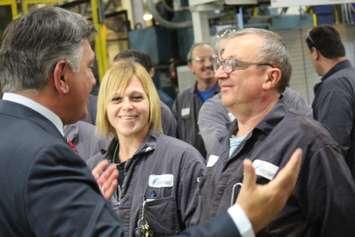 Ontario Finance Minister Charles Sousa, left, speaks with Nemak workers after announcing a $1.5-million government grant for the plant. (Photo by Jason Viau)