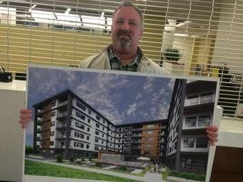 Rob Piroli, owner of Piroli Group Developments, poses for a photo with renderings of his company's proposed condo development for Leamington. April 20, 2015. (Photo by Ricardo Veneza)