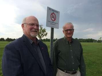 Leamington Mayor John Paterson (L) and Councillor Rick Atkin stand by a sign put up at the Leamington Soccer Complex as a result of Leamington's smoke-free outdoor space bylaw. Photo taken May 27, 2014. (Photo by Ricardo Veneza)