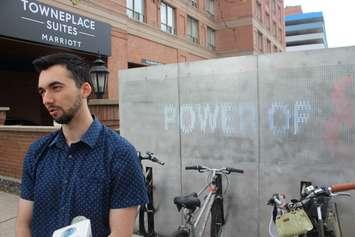 Max Pecoraro, a graduate student at the University of Windsor, shows off the illuminated bike dock he designed on University Avenue West in downtown Windsor, May 24, 2019. The dock was built in cooperation with St. Clair College and the DWBIA. Photo by Mark Brown, Blackburn News. 